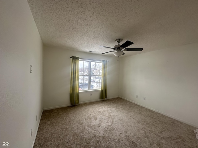 carpeted spare room with a textured ceiling and ceiling fan