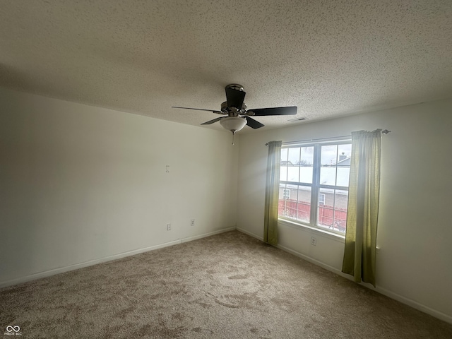 carpeted empty room featuring a textured ceiling and ceiling fan