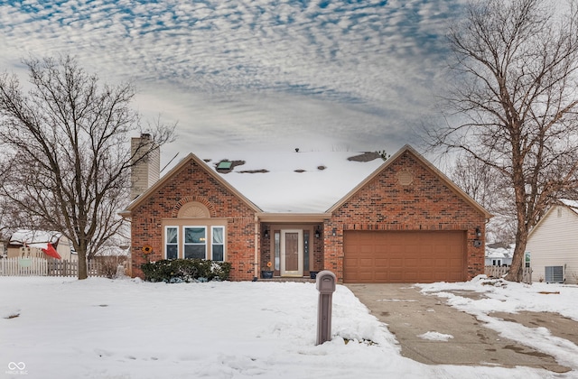 view of front of property with a garage and central AC