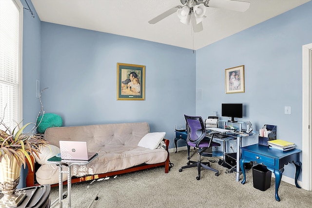 carpeted office featuring ceiling fan