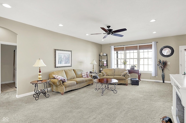 living room with ceiling fan and light colored carpet