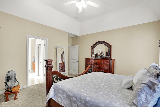 bedroom with a raised ceiling, ceiling fan, and light carpet