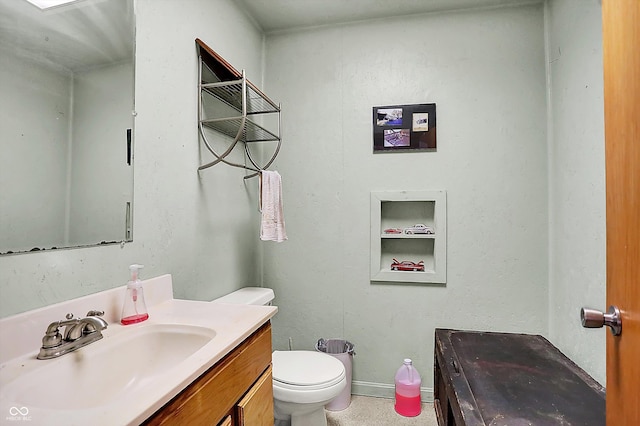 bathroom with toilet and vanity