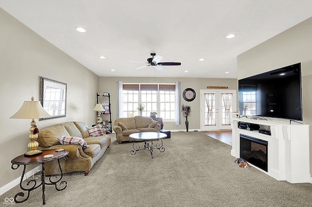 carpeted living room with french doors, ceiling fan, and plenty of natural light