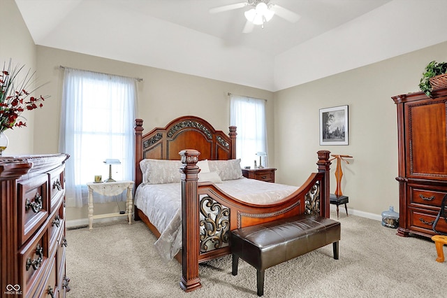 bedroom featuring light colored carpet, ceiling fan, and a tray ceiling