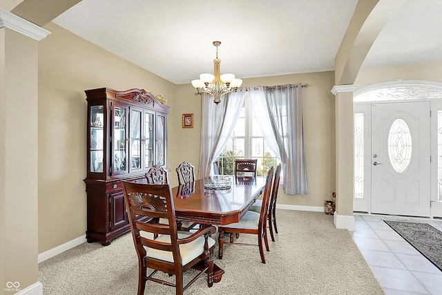 carpeted dining area with a notable chandelier