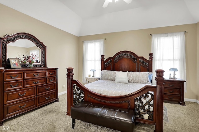 bedroom featuring vaulted ceiling, light carpet, and ceiling fan