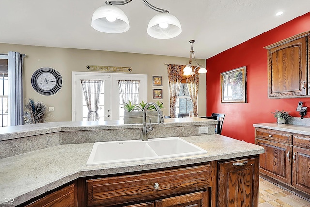 kitchen featuring sink, hanging light fixtures, and french doors