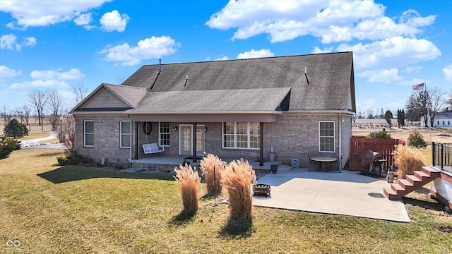 10194 E 900 N, Markleville, IN 46056 - rear view of house with a fire pit, a patio area, brick siding, and a lawn