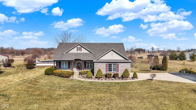 10194 E 900 N, Markleville, IN 46056 - view of front of home with brick siding, concrete driveway, roof with shingles, and a front lawn