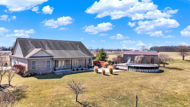 10194 E 900 N, Markleville, IN 46056 - back of property with a shingled roof, a swimming pool, a patio area, and a yard