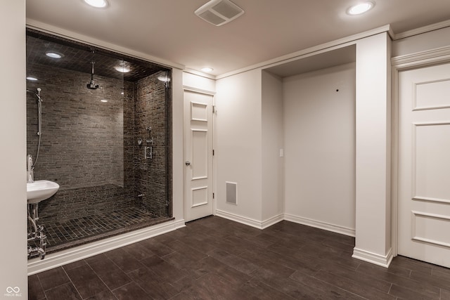 bathroom with an enclosed shower and ornamental molding