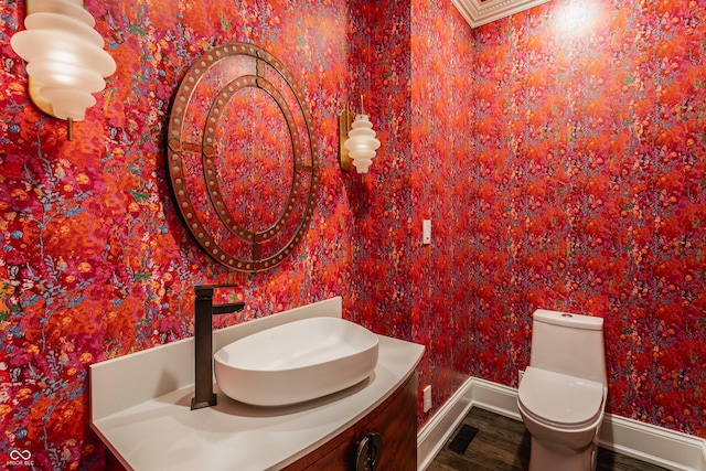 bathroom featuring hardwood / wood-style flooring, toilet, and vanity