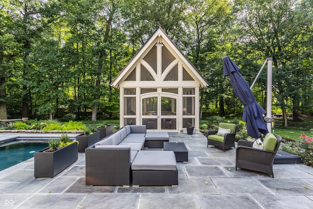 view of patio featuring an outdoor living space with a fireplace