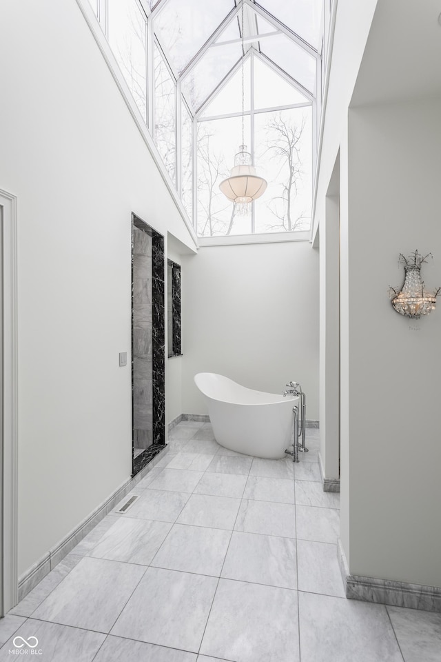 bathroom with a bathtub and a towering ceiling