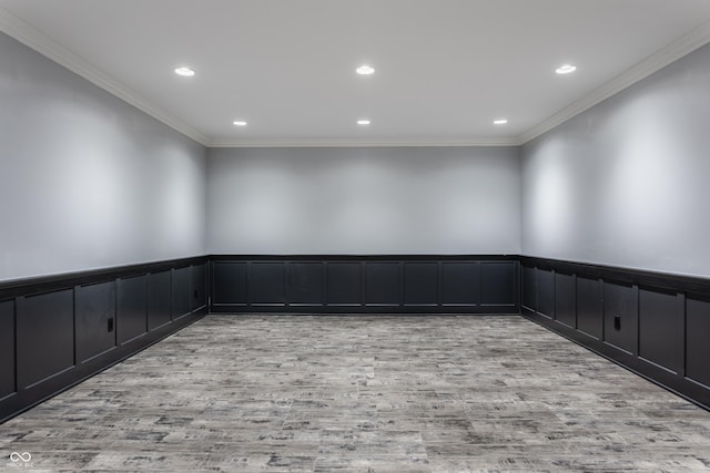 empty room featuring light hardwood / wood-style flooring and crown molding