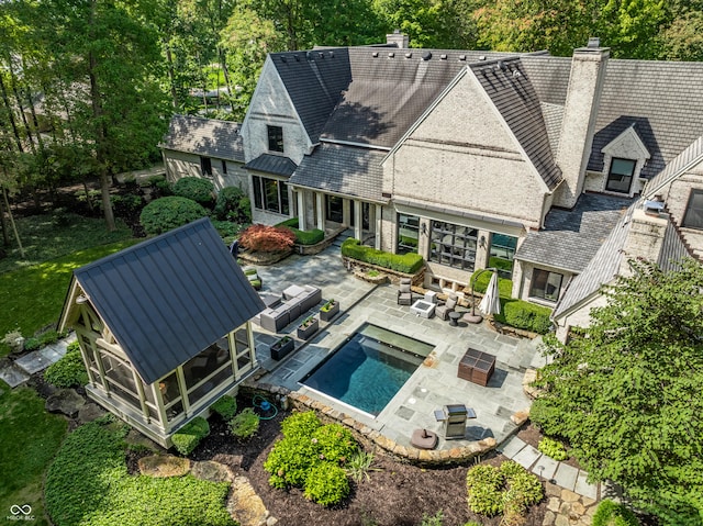 back of property featuring a patio area and a sunroom