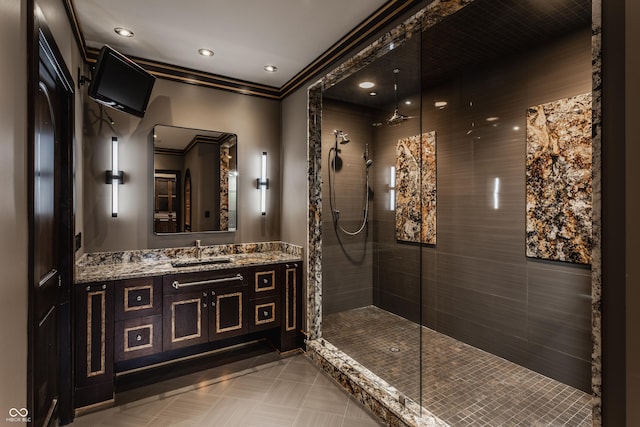 bathroom with vanity and a tile shower