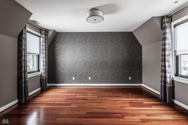 bonus room featuring lofted ceiling and wood-type flooring