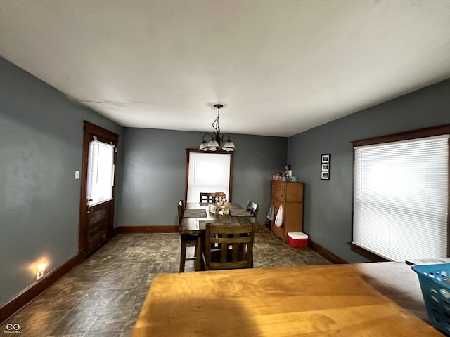 dining space with a notable chandelier