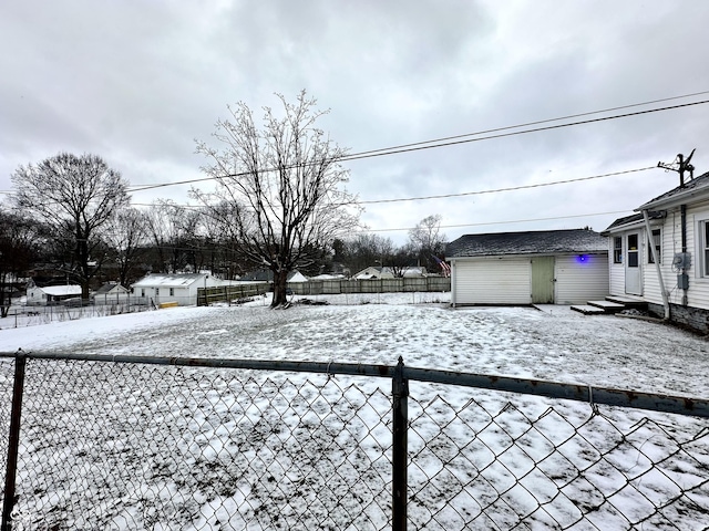 yard layered in snow featuring a storage shed