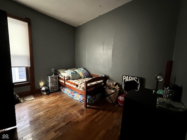 bedroom with hardwood / wood-style flooring