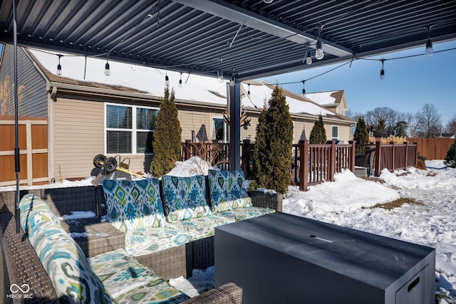 snow covered patio featuring an outdoor hangout area and a hot tub