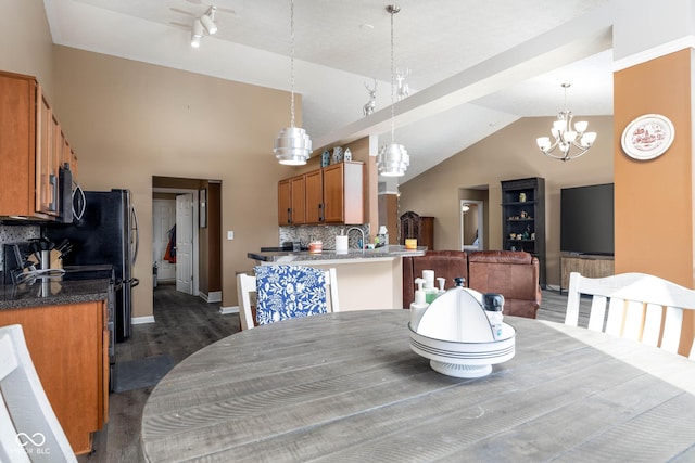 dining room with lofted ceiling, a chandelier, and dark hardwood / wood-style floors