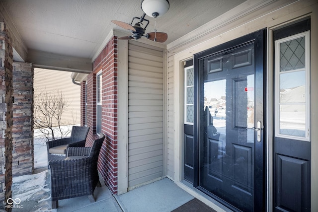 entrance to property with ceiling fan