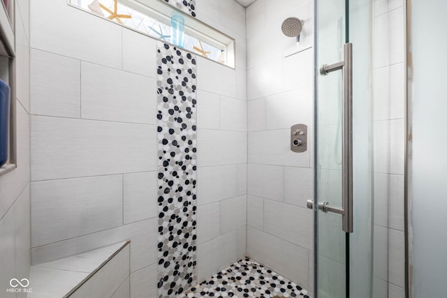 bathroom with a shower with door