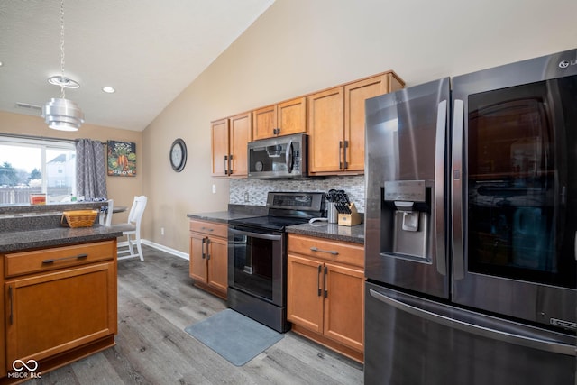 kitchen featuring lofted ceiling, tasteful backsplash, light hardwood / wood-style flooring, stainless steel fridge with ice dispenser, and black range with electric cooktop