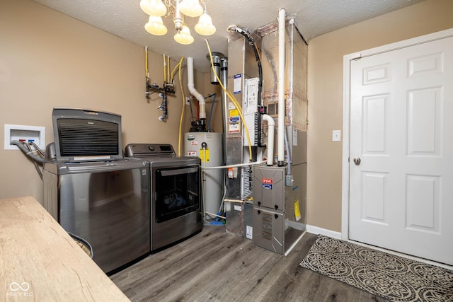 clothes washing area featuring separate washer and dryer, hardwood / wood-style floors, a textured ceiling, an inviting chandelier, and gas water heater