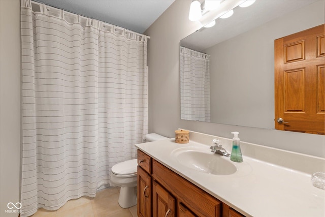 bathroom featuring tile patterned floors, vanity, toilet, and walk in shower