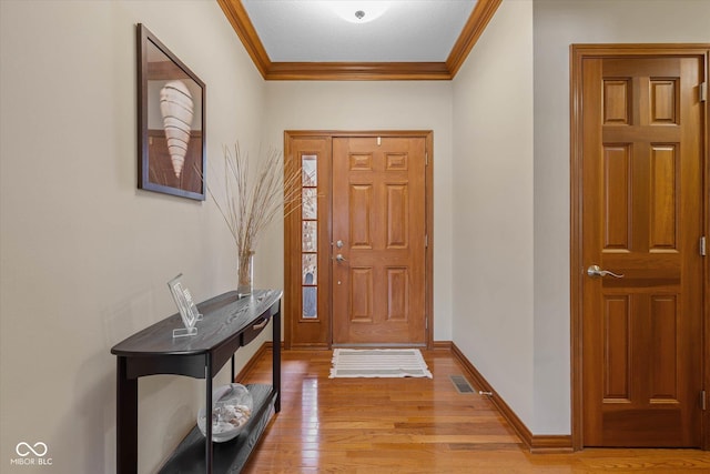 foyer entrance with wood-type flooring and crown molding