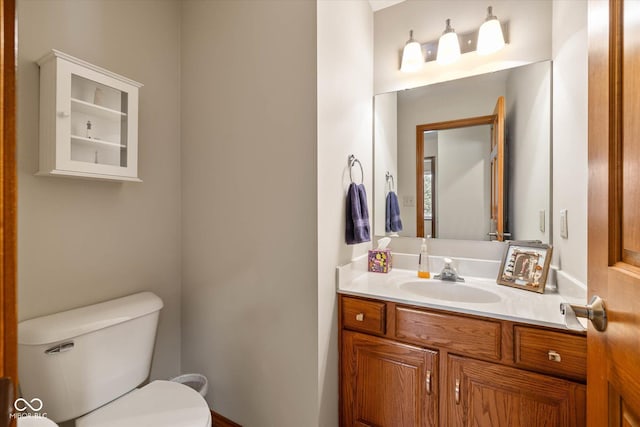 bathroom featuring toilet and vanity