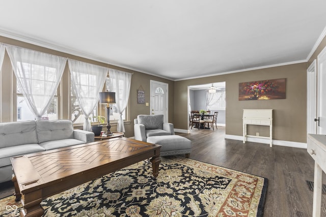 living room with dark wood-type flooring and crown molding