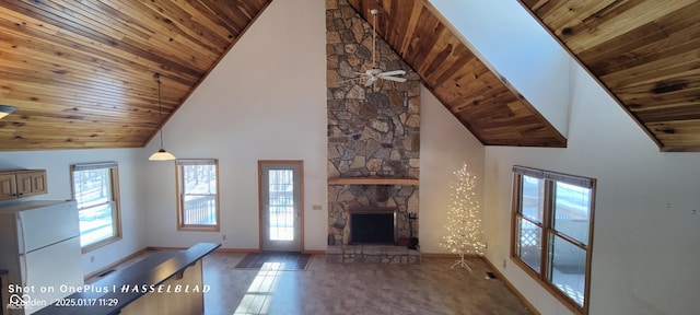 unfurnished living room with wood ceiling, high vaulted ceiling, ceiling fan, a fireplace, and tile patterned flooring