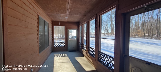 unfurnished sunroom featuring wood ceiling