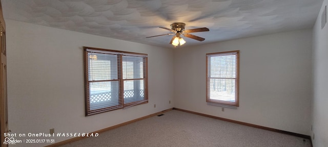 empty room with ceiling fan and carpet flooring