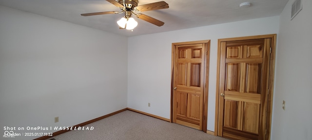 unfurnished bedroom featuring light carpet and ceiling fan