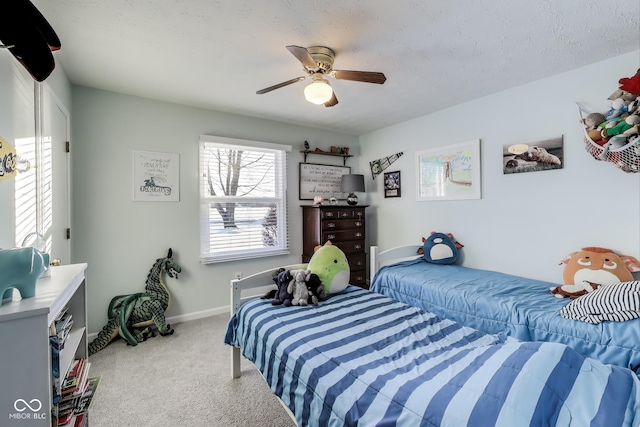 carpeted bedroom with a textured ceiling and ceiling fan