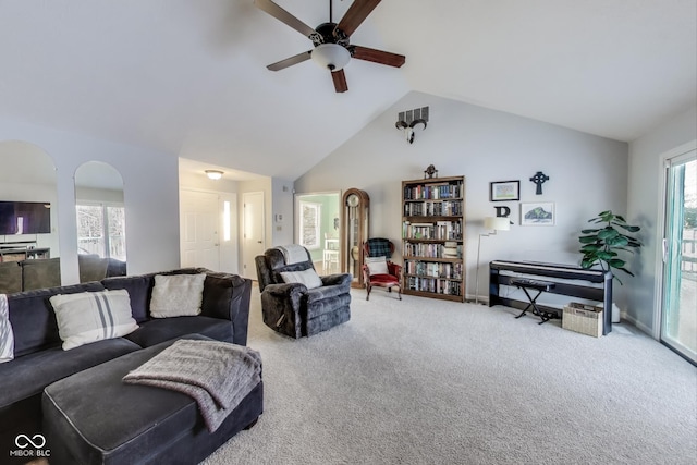 living room featuring vaulted ceiling, ceiling fan, carpet, and plenty of natural light