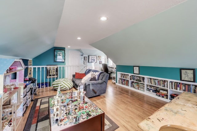 playroom featuring lofted ceiling and hardwood / wood-style floors