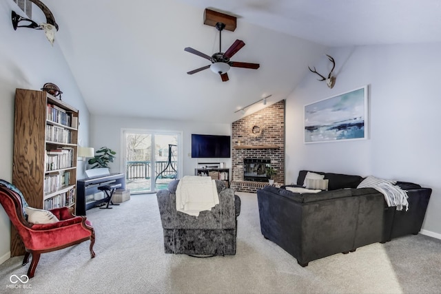 living room with lofted ceiling, a brick fireplace, ceiling fan, and carpet flooring