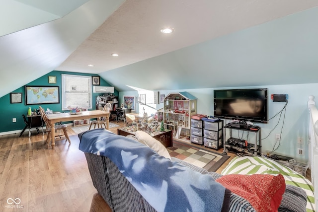 living room with light wood-type flooring and vaulted ceiling