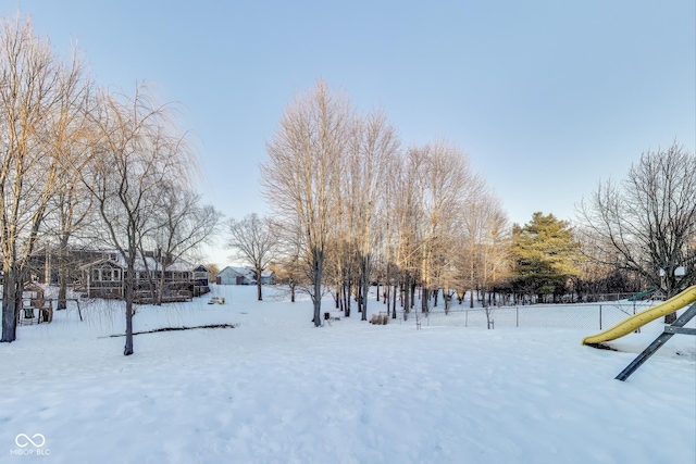 snowy yard with a playground