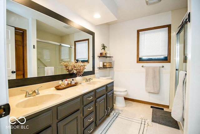 bathroom featuring toilet, an enclosed shower, tile patterned flooring, and vanity