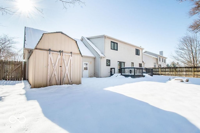 view of snow covered rear of property