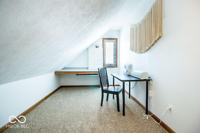 office area featuring a textured ceiling, light carpet, and lofted ceiling