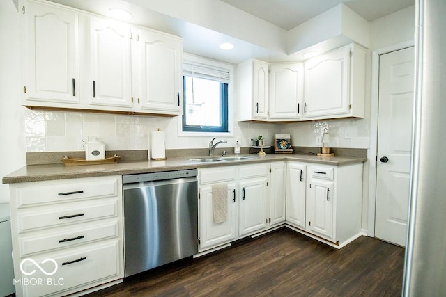 kitchen with stainless steel dishwasher, white cabinets, sink, and dark wood-type flooring